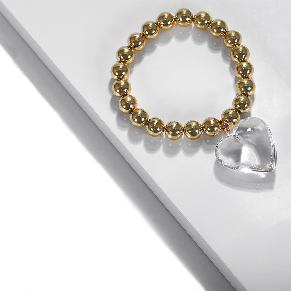 Gold Tone Stretch Bead bracelet with Clear Hear Drop